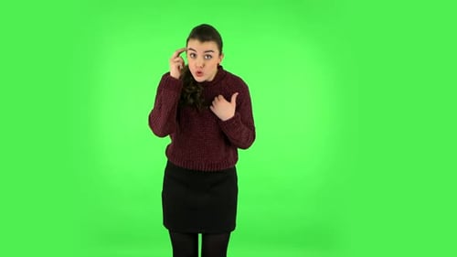 Indignant Woman Throwing Up Hands Expressing She Is Innocent, Twists His Finger at His Temple