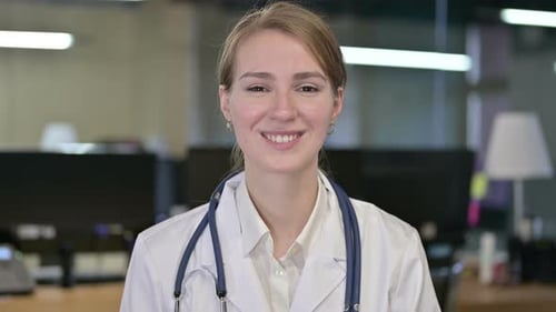 Smiling Woman Doctor Wearing a Lab Coat and Stethoscope