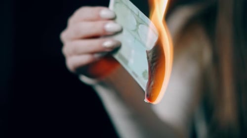 A Female Hand Is Holding Burning Euro Cash Money