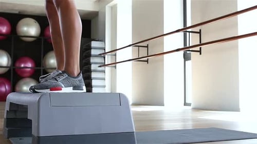 Woman Doing Step Jumps at the Gym. Slow Motion