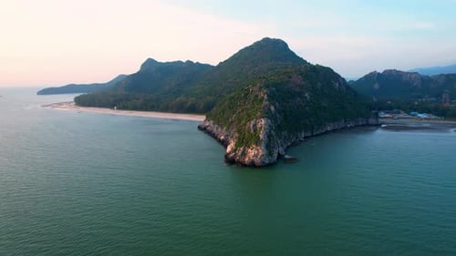 4K aerial view of mountain coast near beautiful beach and sea. Flight over sea.