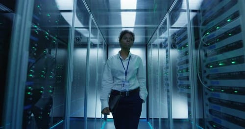 Woman Walking Confidently Through High Tech Server Room