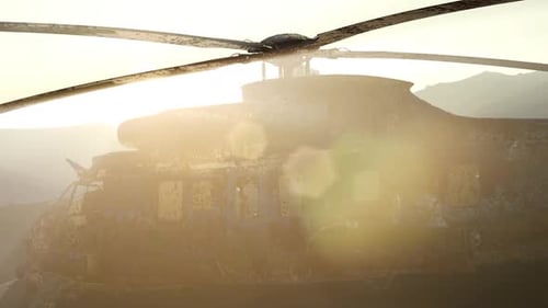 Old Rusted Military Helicopter in the Desert at Sunset