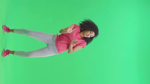 Woman Dancing on Green Screen in Studio