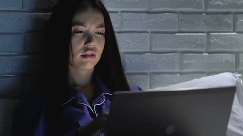 Woman Working Late on Laptop in Bed at Night