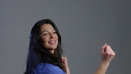 Woman Dancing and Celebrating in Studio