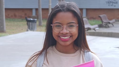 Portrait of Smiling African American College Student Looking at Camera