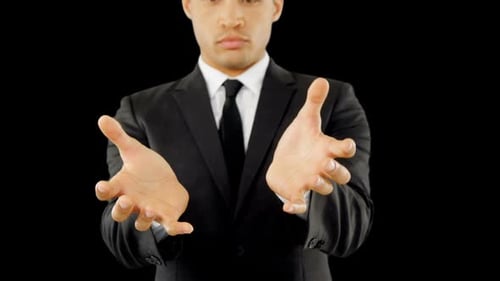 Man in Suit Offers Hands to the Viewer