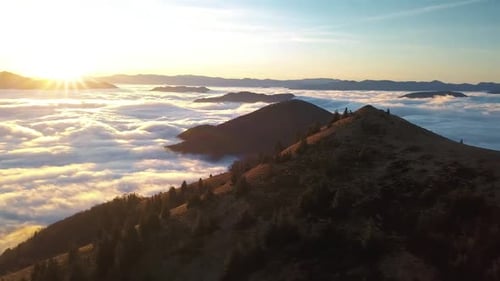 Aerial View of Mountains Above the Clouds at Sunrise