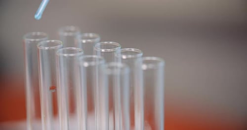 Extreme Close Up of Pipette Dropping Water Into Sample Tube at Laboratory