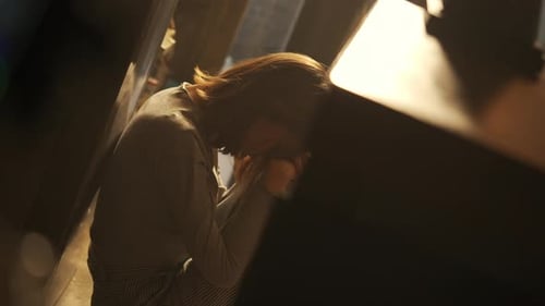 4K Asian woman sitting on the floor hugging herself with sadness
