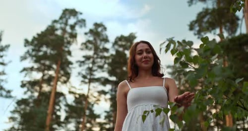 Young and Happy Woman Walks Through the Forest and Smiles Happy Moments of Life