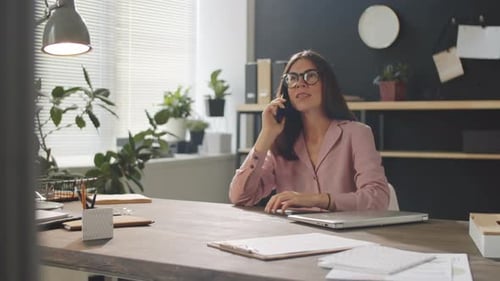Cheerful Business Lady Speaking on Phone in Office