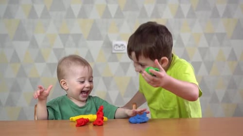 Brothers Playing Together With Modeling Clay