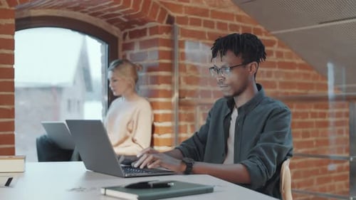Diverse Young Colleagues Working in Comfortable Loft Office