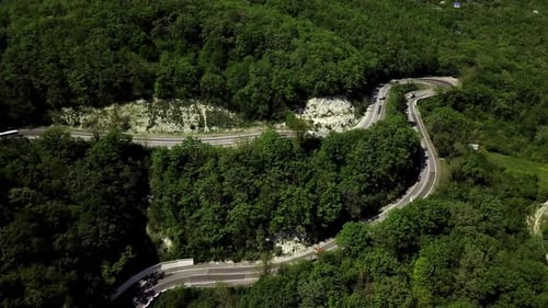 Aerial View of a Curved Winding Road Trough the Mountains