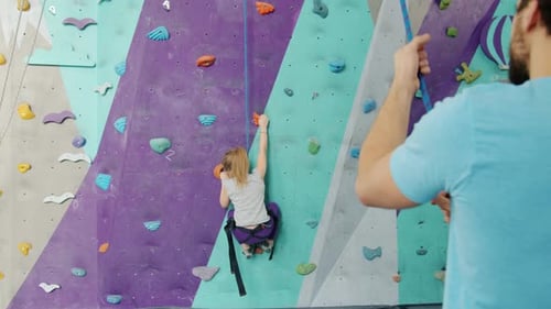 Child Climbing Wall at Indoor Climbing Gym