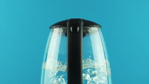Water Boiling Vigorously in a Glass Kettle