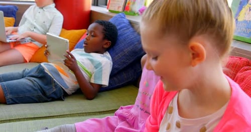 School children having fun in the school library 4k