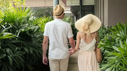 Couple on Vacation Exploring Hotel Area at Tropical Resort