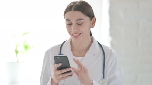 Female Doctor Using Smartphone for Telehealth Consultation
