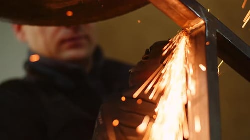 Angle Grinder Cutting Metal at Workshop
