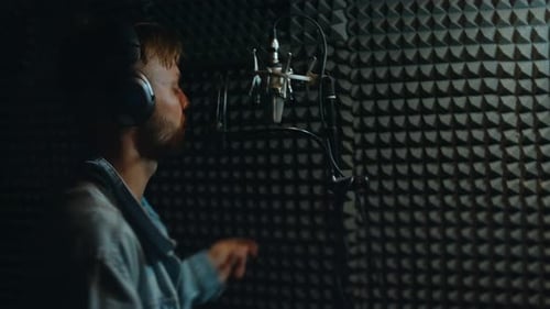 Young adult recording audio in a professional studio