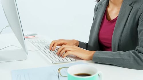 Businesswoman working at desk 4k