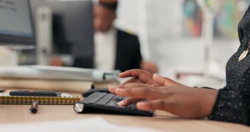 Closeup of a Black Keyboard From a Computer Standing on a Wooden Desk on It a Working Woman Young