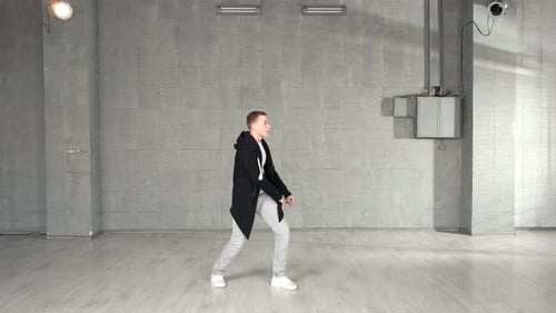 Trendy Caucasian Boy Performing Dance Moves in Studio