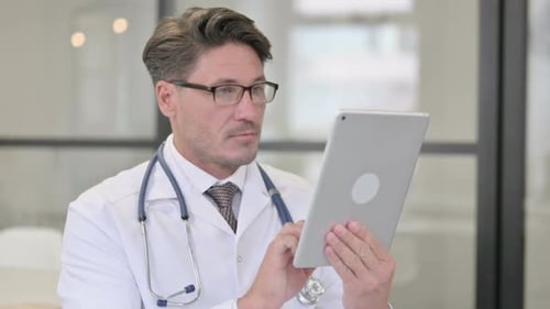 Doctor Using Tablet in Hospital Workplace