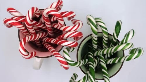 Overhead View of Holiday Candy Canes in Mugs