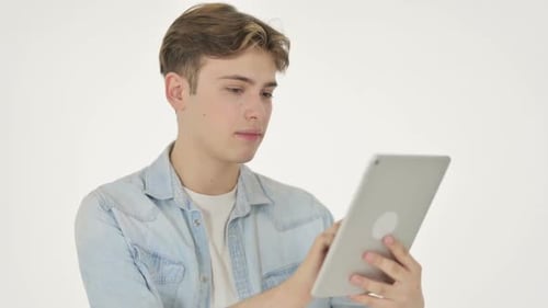 Young Adult Using Tablet in White Studio