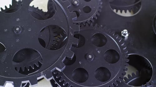 Rotating Black Gears in Close-Up