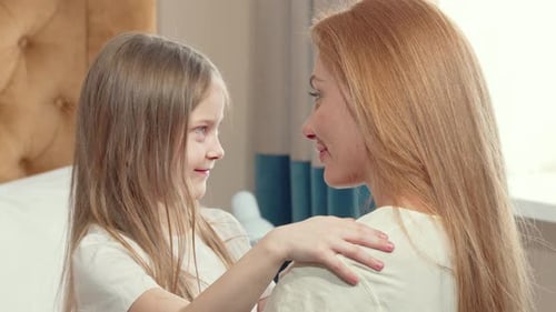 Loving Child Hugging Mother Indoors