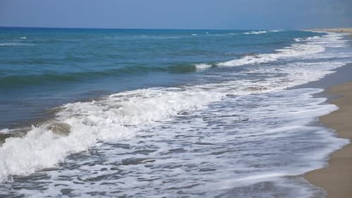 Marine Scene of Empty Sand Beach with Big Ocean Waves Crashing on Shoreline. Beautiful Sunny Day on