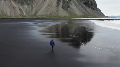 Drone Of Photographer Walking Black Beach Towards Vestrahorn