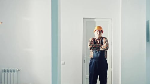 Portrait of a Man Construction Builder in Orange Helmet the Office Center