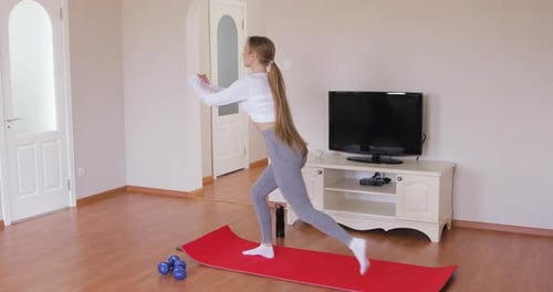 Fit athlete working out for well being in domestic gym, training legs muscles doing lunges exercise