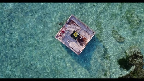 Man and lady tanning on idyllic shore beach journey by blue ocean and white sandy background of the