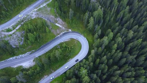 Aerial View of Winding Road in the Mountains and Green Forest