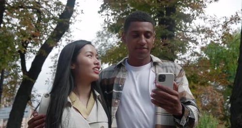 Beautiful Heterosexual Loving Couple Two Friends Walking at the Street Close to Each Other and