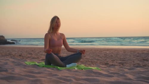 Woman Practice Yoga Lotus Pose to Meditation with Summer Vacation Beach Happiness and Relaxation