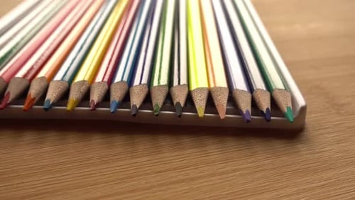 Colorful Pencils Arranged Neatly on Wooden Table