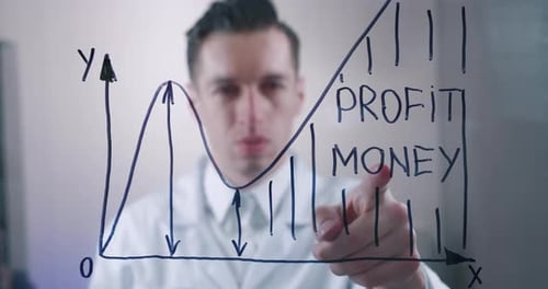 Man Drawing Business Growth Graph on Glass Board