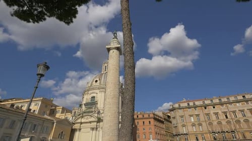 Trajan's Column and Church in Rome Under Blue Sky