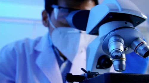 Scientist Looking Through Microscope in Lab Close Up