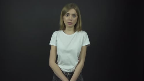 Scared Woman Glances Around with Fearful Expression