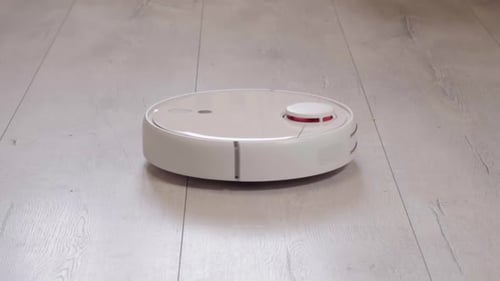 Robotic Vacuum Cleaner Moving Across Floor