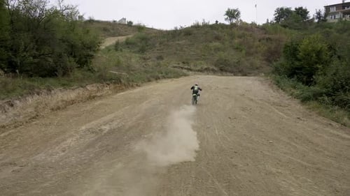 Motocross Rider on Dirt Bike on Rural Track